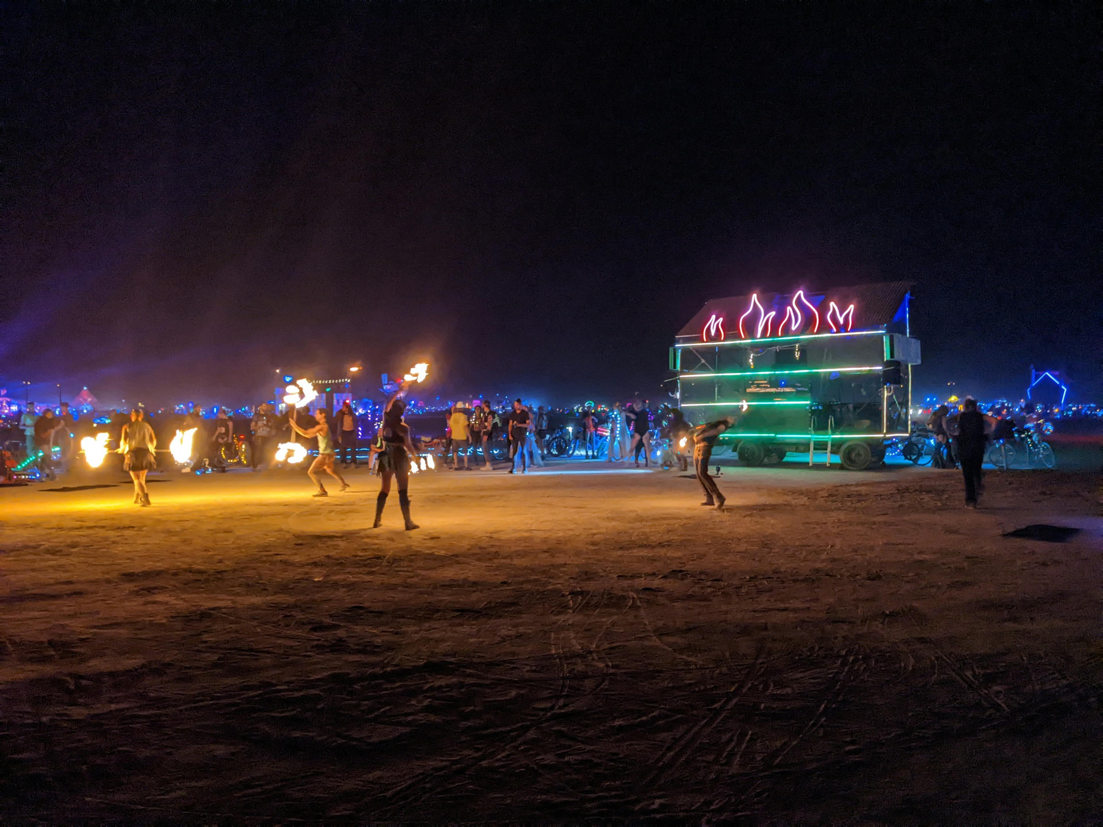 Dumpy Fuego hosts a fire jam in front of the temple at Burning Man 2022